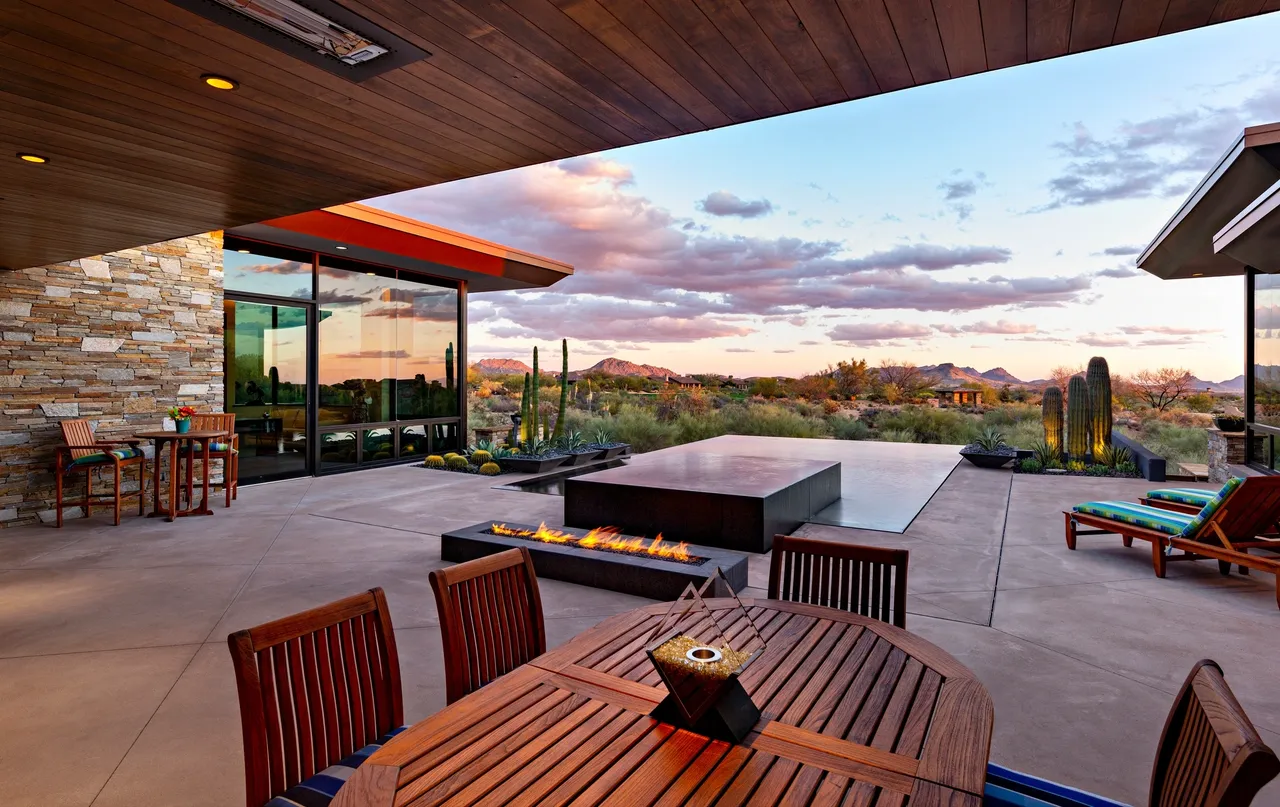 A patio with a fire pit and table in it
